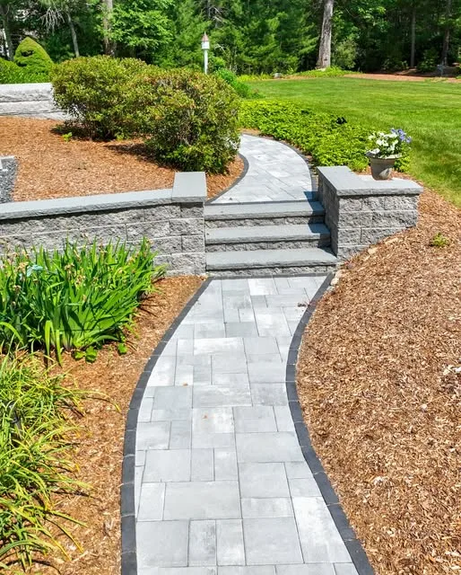 Finished paver walkway and stone steps through planting beds