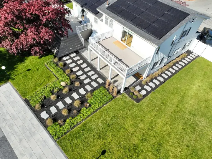 Green lawn, planting beds and stone paths from the Contrast Landscape portfolio